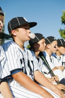 USA, California, Ladera Ranch, Boys (10-11) from little league sitting on dugout.