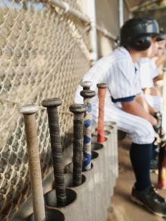 USA, California, Ladera Ranch, Boys (10-11) from little league sitting on dugout.