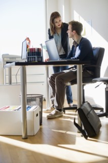 USA, New Jersey, Jersey City, Two young people in office.