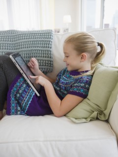 USA, New Jersey, Jersey City, Girl (8-9) using palmtop. Photo : Jamie Grill Photography