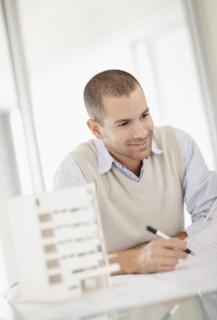 South Africa, Smiling architect working in office. Photo : momentimages