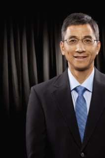 USA, Utah, Provo, Portrait of businessman standing in front of black curtain. Photo : FBP