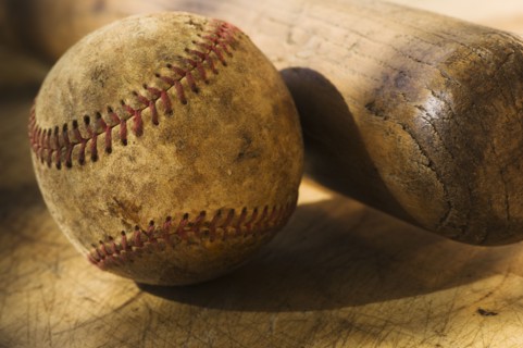 Antique baseball with baseball bat.