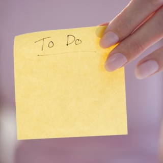 USA, New Jersey, Jersey City, Close-up view of woman hand holding adhesive note for writing down