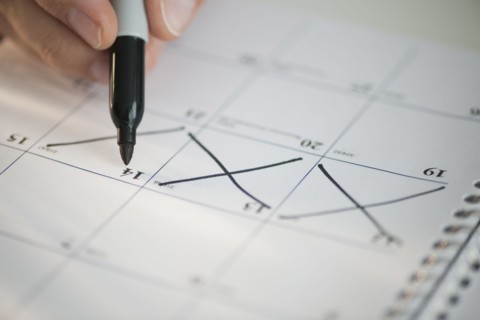 USA, New Jersey, Jersey City, Man writing on calendar.