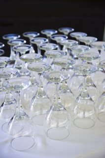 Rows of wine glasses on table .