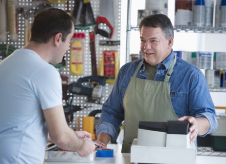 USA, New Jersey, Jersey City, Shop owner serving customer in hardware shop.
