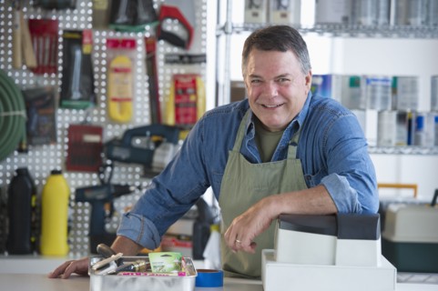 USA, New Jersey, Jersey City, Portrait of hardware shop owner at counter.