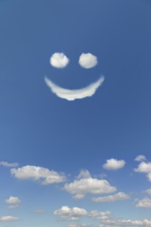 Clouds forming smiley face in sky.
