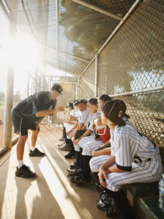 USA, California, Ladera Ranch, Boys (10-11) from little league sitting on dugout while coach