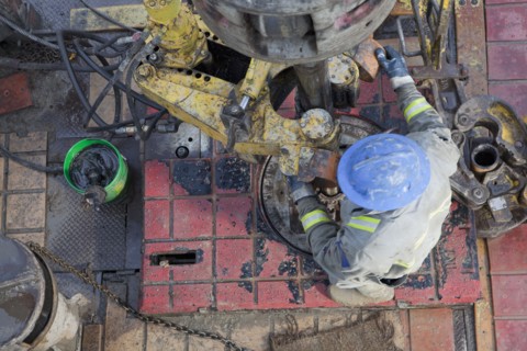 Oil worker drilling for oil on rig. Photo : Dan Bannister