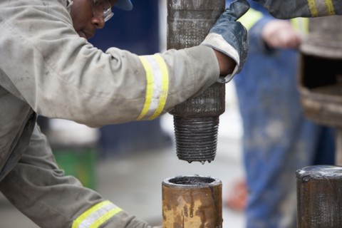 Oil worker drilling for oil on rig. Photo : Dan Bannister