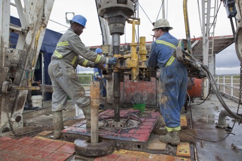 Oil workers drilling for oil on rig. Photo : Dan Bannister