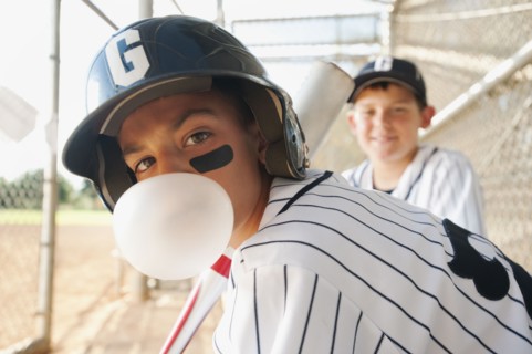 USA, California, Ladera Ranch, boys (10-11) from little league baseball team on dugout.