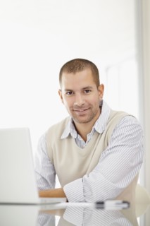 South Africa, Portrait of young man with laptop. Photo : momentimages