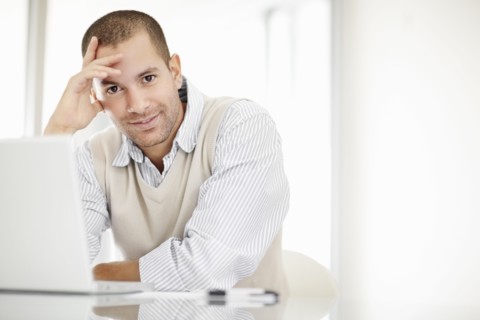 South Africa, Portrait of young man with laptop. Photo : momentimages