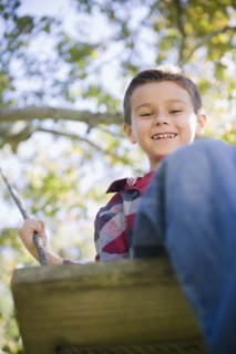 USA, New York, Flanders, Boy (8-9) playing in garden. Photo : Jamie Grill Photography