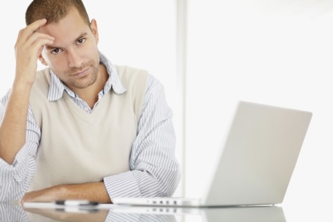 South Africa, Portrait of young man with laptop. Photo : momentimages
