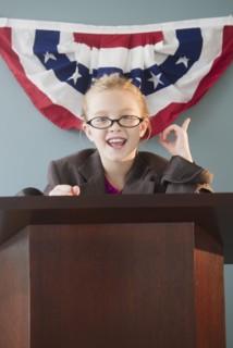 USA, New Jersey, Jersey City, Girl (8-9) giving speech from pulpit. Photo : Jamie Grill Photography