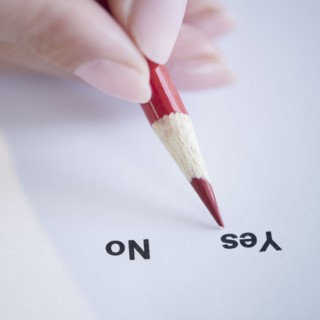 USA, New Jersey, Jersey City, Close-up view of woman's hand filling in form. Photo : Jamie Grill