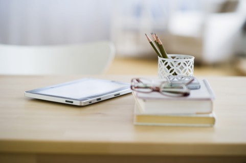 USA, New Jersey, Jersey City, Digital tablet and stationery on desk.