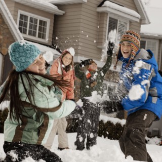 USA, Utah, Provo, Boys (10-11, 12-13) and girls (10-11, 16-17) having snow ball fight in front of