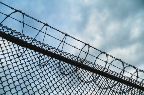 USA, New York, New York City, Barbed wire fence.