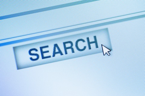 Curser by search icon on computer screen.