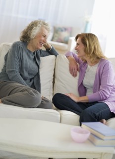 USA, New Jersey, Jersey City, Mother and daughter talking on sofa.