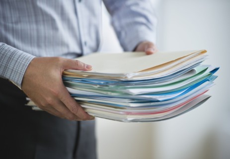 USA, New Jersey, Jersey City, Businessman carrying paperwork.
