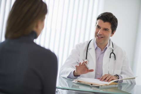 USA, New Jersey, Jersey City, Doctor talking with female patient in office.