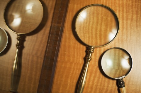 USA, New Jersey, Jersey City, Two magnifying glasses reflected in mirror.