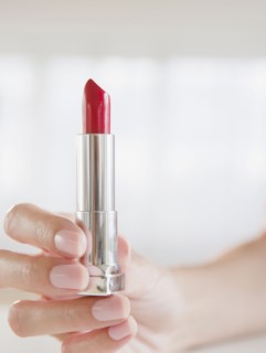 USA, New Jersey, Jersey City, Woman's hand holding lipstick. Photo : Jamie Grill Photography