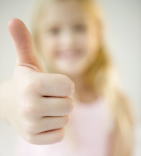 USA, New Jersey, Jersey City, Girl (8-9) with thumb-up. Photo : Jamie Grill Photography