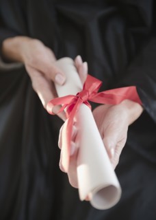 USA, New Jersey, Jersey City, Close-up view of woman hands holding diploma. Photo : Jamie Grill