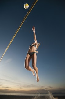 USA, California, Los Angeles, woman playing beach volleyball.