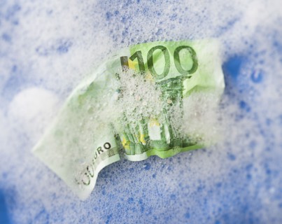 One hundred euro note soaking in soap sud. Photo : Mike Kemp