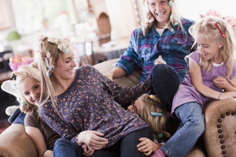 USA, Utah, family portrait of sisters (6-7, 8-9, 12-13, 14-15, 16-17) on sofa having fun. Photo :