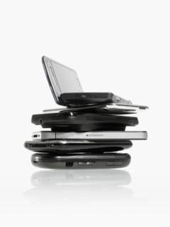 Studio shot of pile of laptops and palmtops. Photo : David Arky