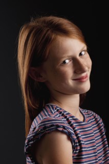 Portrait of redhead girl (10-11), studio shot. Photo : FBP