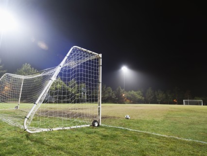 USA, California, Ladera Ranch, illuminated soccer field at night.