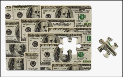 Puzzle with one hundred dollar bills. Photo : Mike Kemp