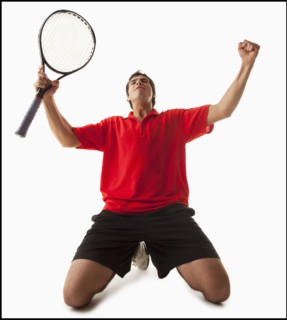Young man playing tennis winning. Photo : Mike Kemp