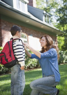 USA, New York, Flanders, Mother assisting boy (8-9) before departure to school. Photo : Jamie Grill