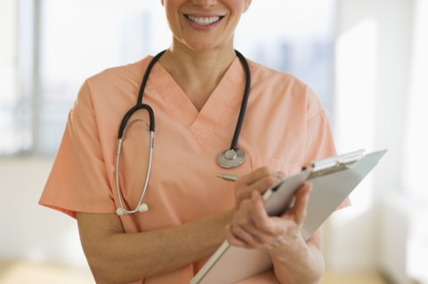 USA, New Jersey, Jersey City, Female doctor writing medical report.