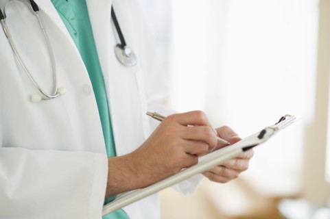 USA, New Jersey, Jersey City, Male doctor writing medical report.
