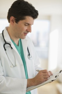 USA, New Jersey, Jersey City, Male doctor writing medical report.