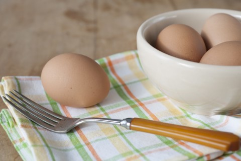 Bowl of boiled eggs with fork.