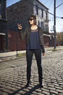 USA, New York City, Brooklyn, woman in street using phone. Photo : Shawn O'Connor