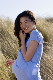 USA, California, Point Reyes, Portrait of young woman standing in long grass. Photo : Noah Clayton